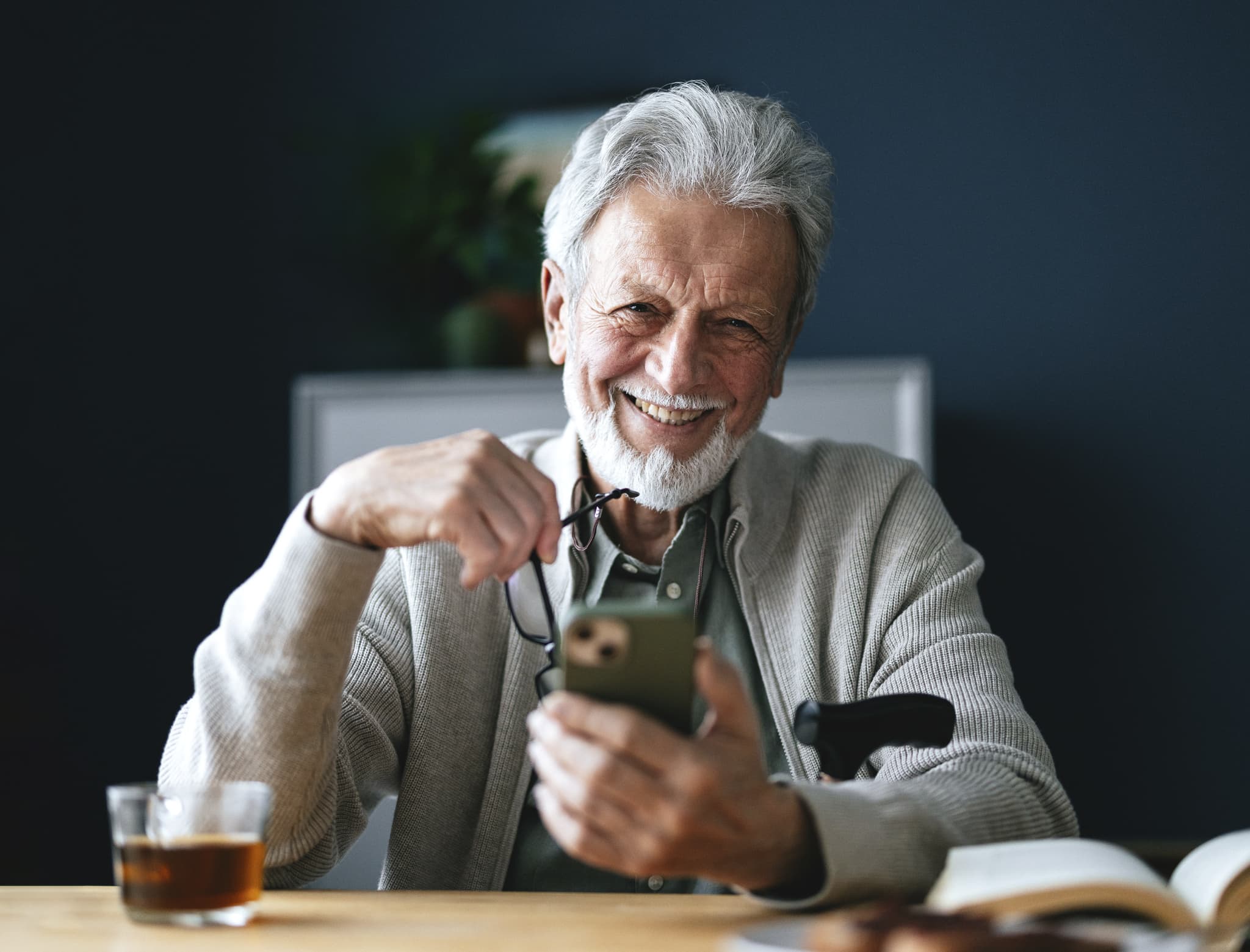 Smiling man looking at his cell phone.