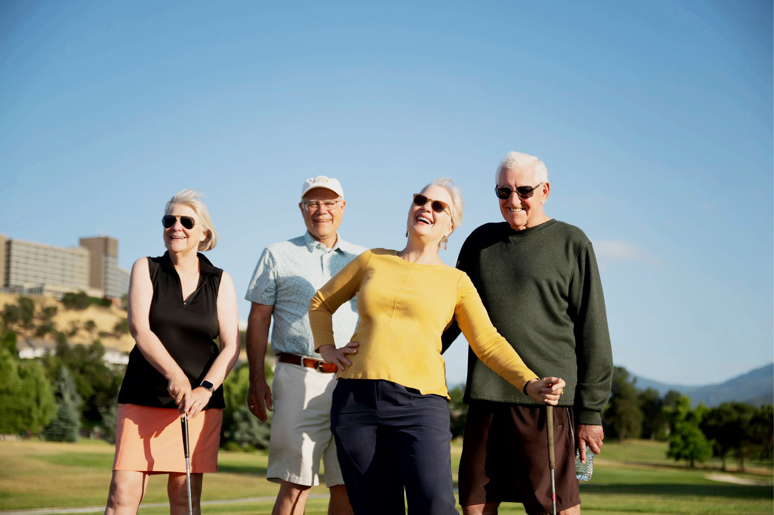 Four people on a golf course.